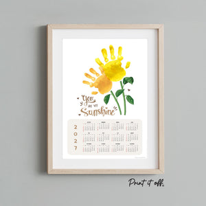 Sunflower handprint art calendar made using a child's painted handprint with printable 2027 calendar design.